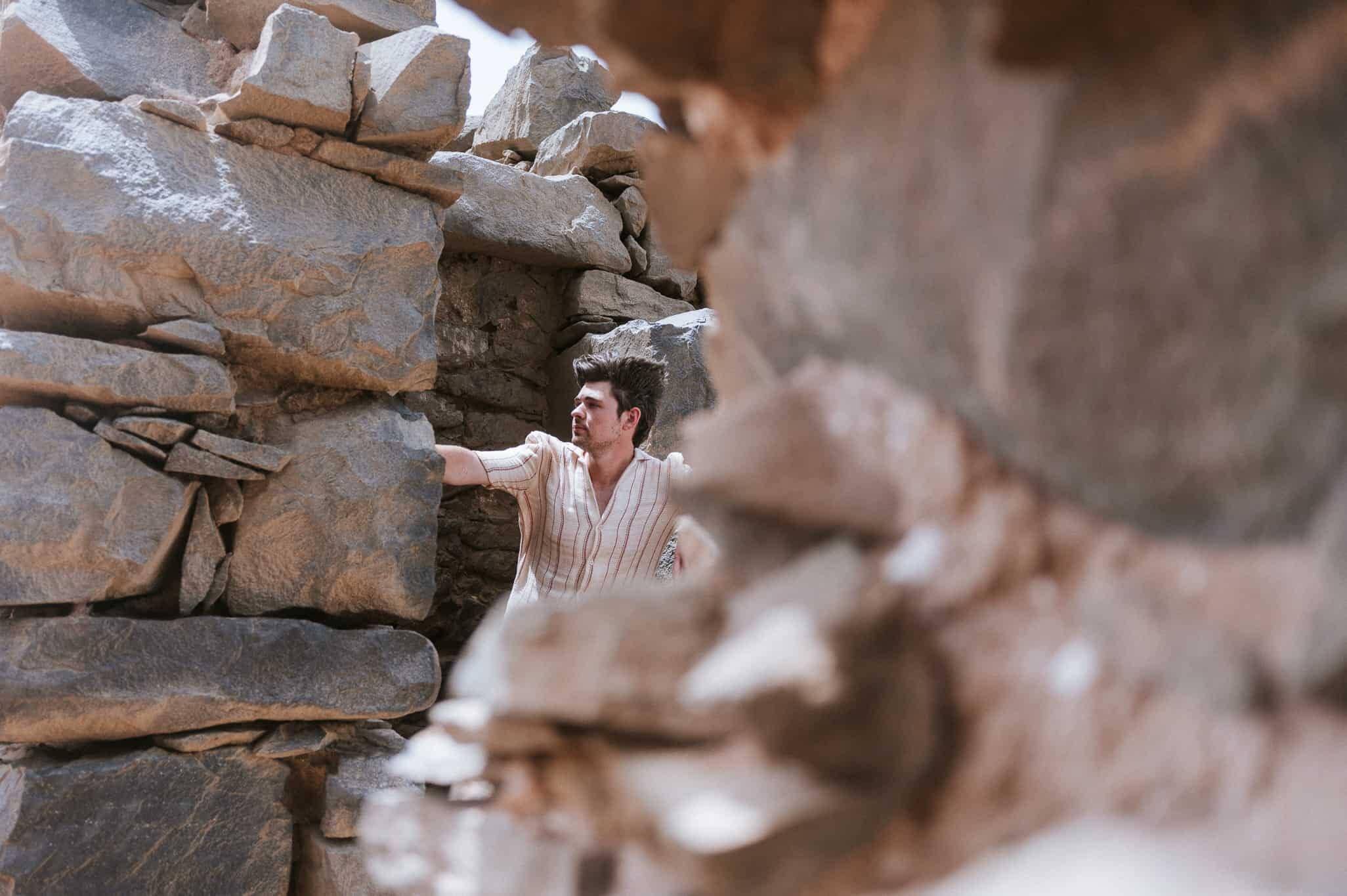 Man standing rock wall