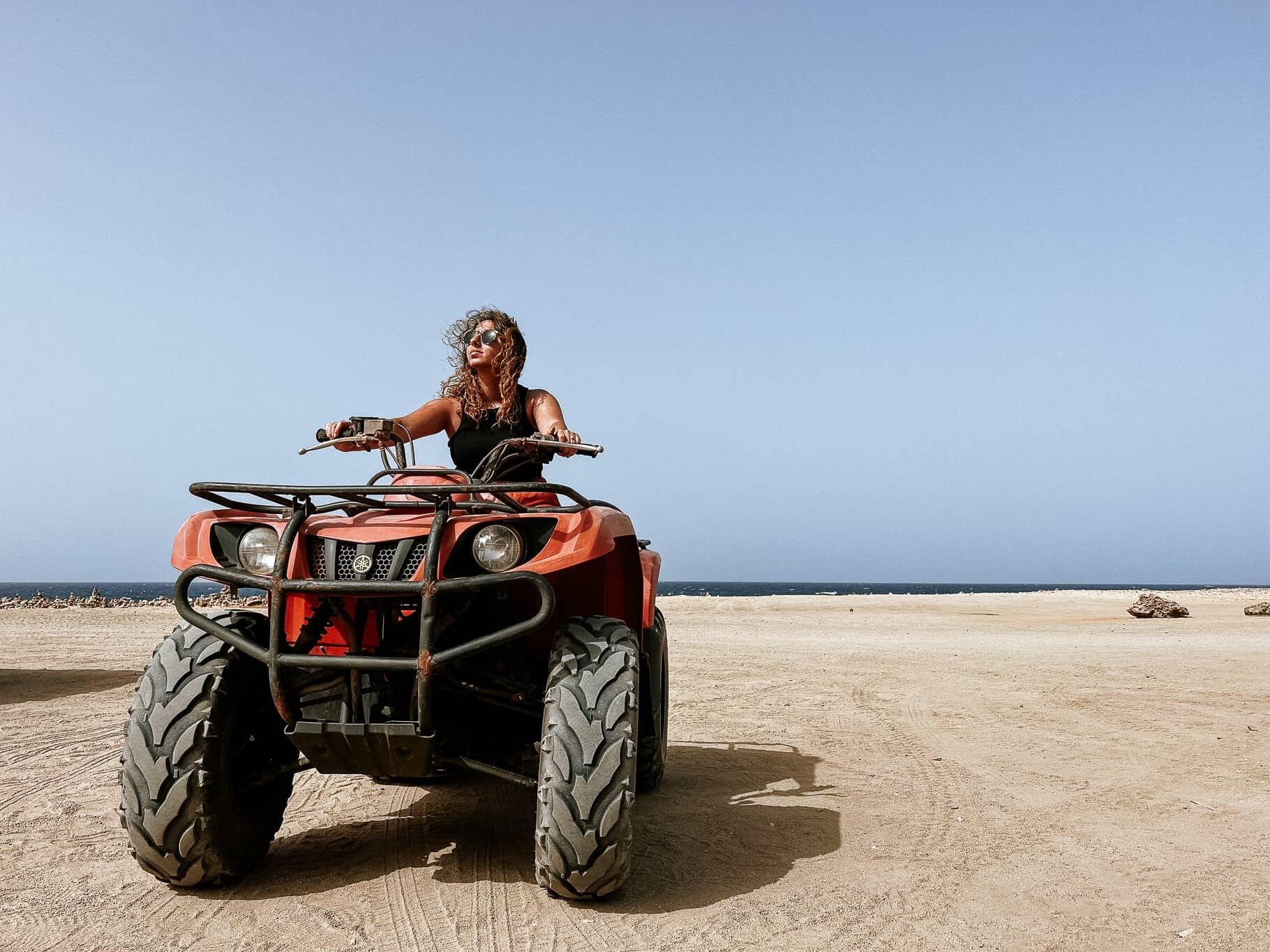 Woman riding ATV beach Aruba