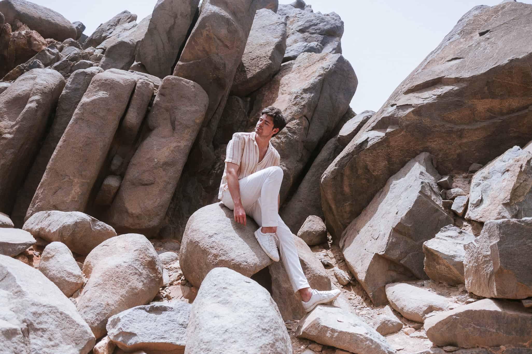 Woman sitting rock desert