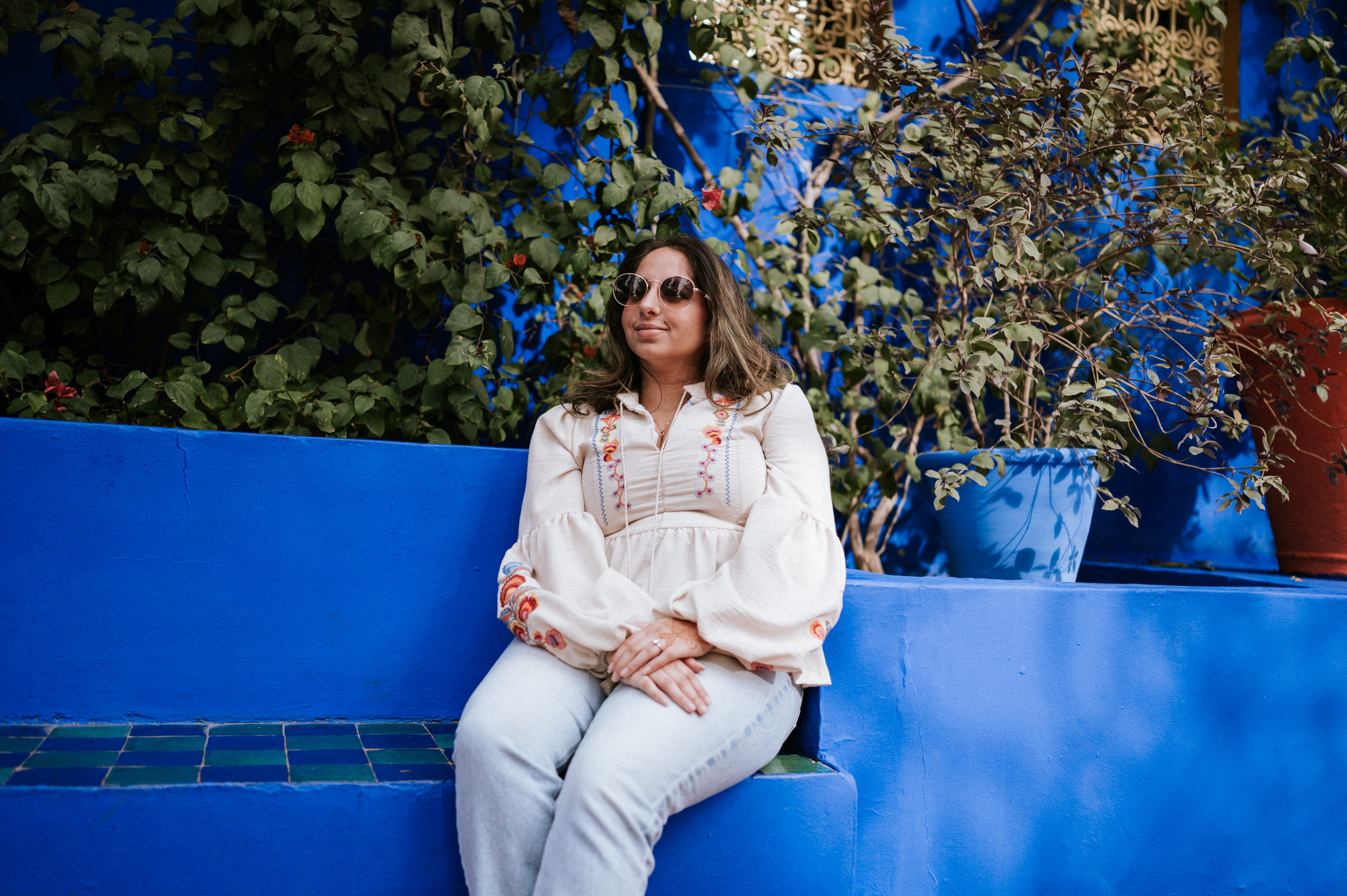 Woman sitting blue bench