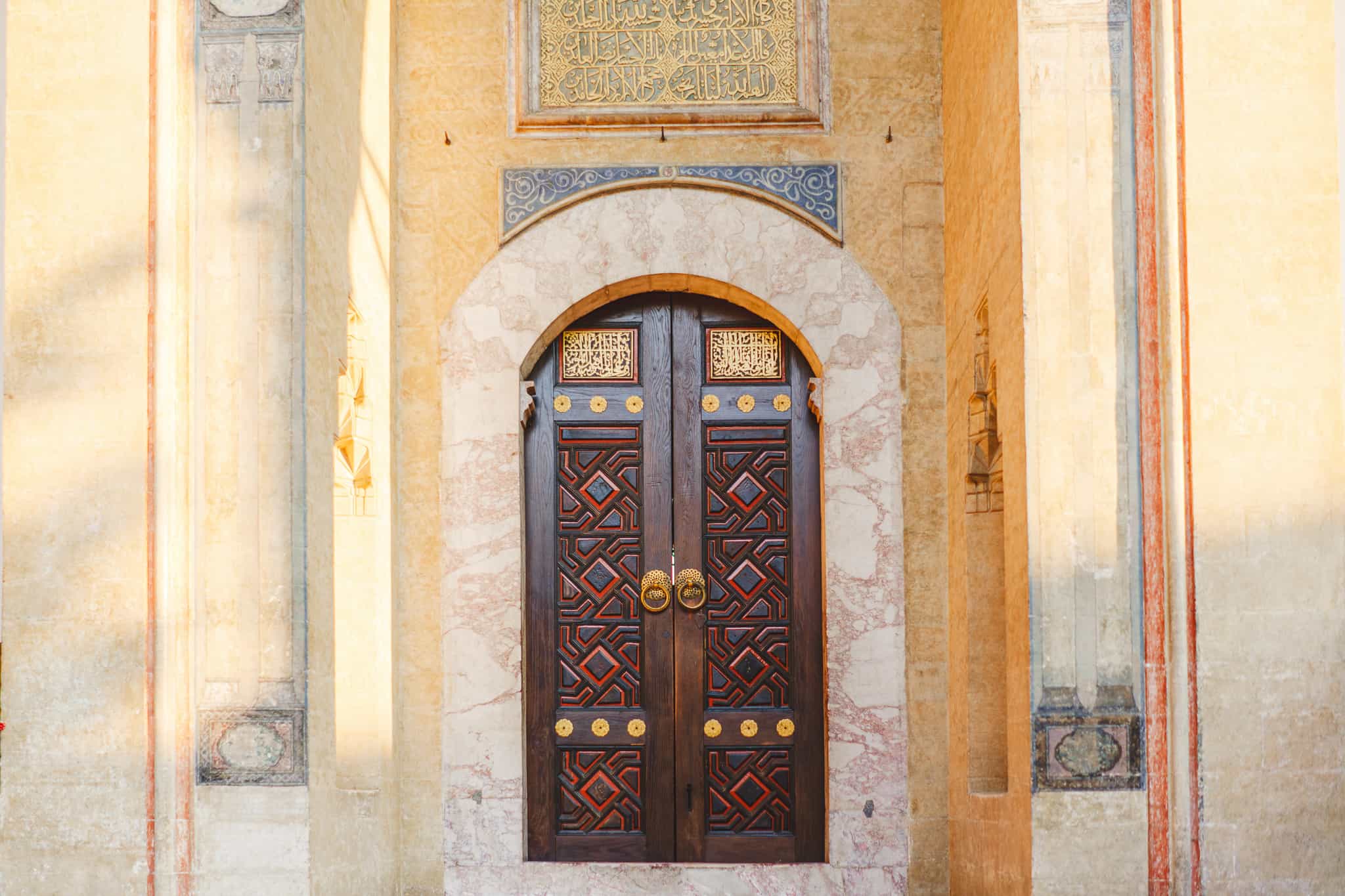An old ornate wooden door with gold handles in the old city of Sarajevo Bosnia and Herzegovina