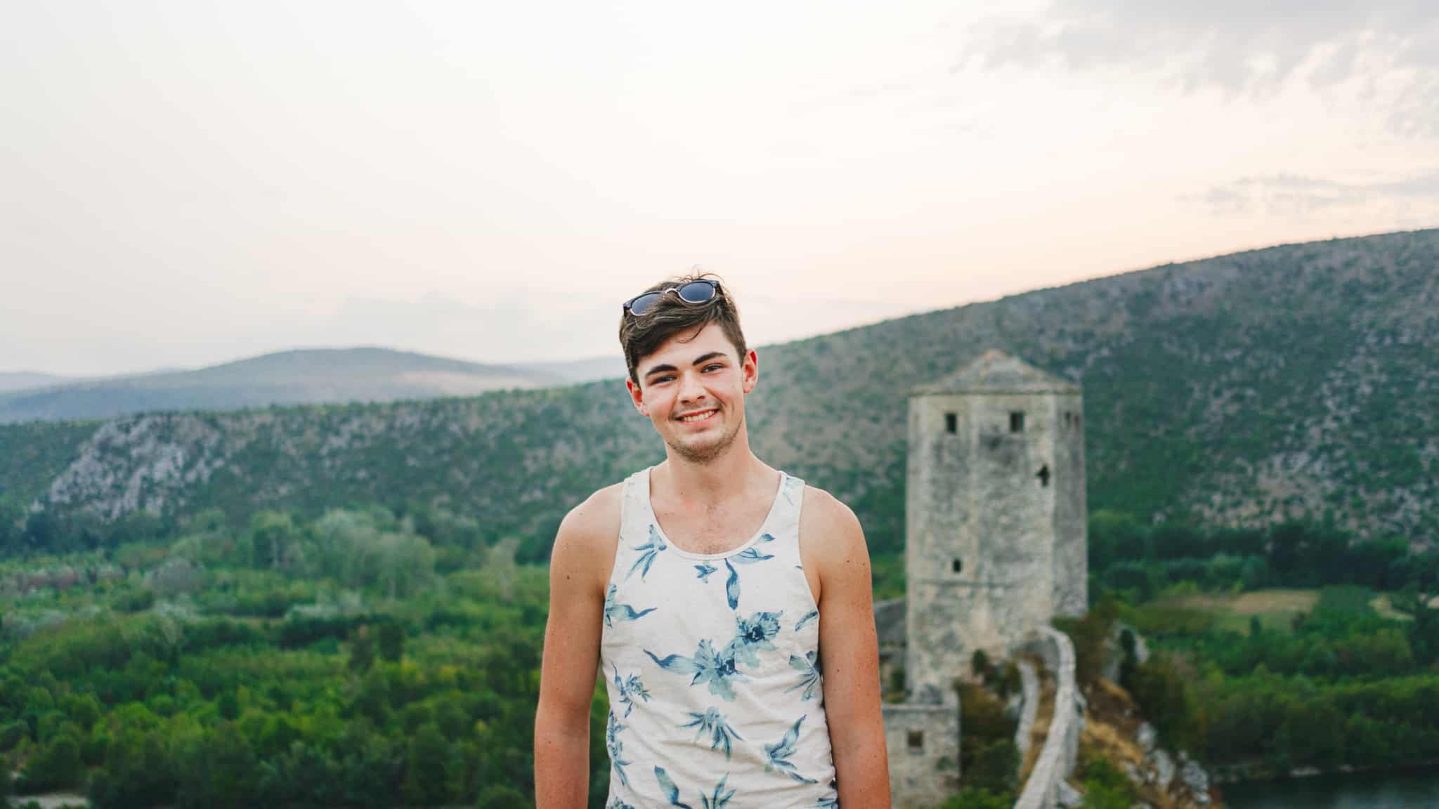 Tristen Wallace at the top of Stjepan Grad aka Blagaj Castle with the hills of Mostar in the background