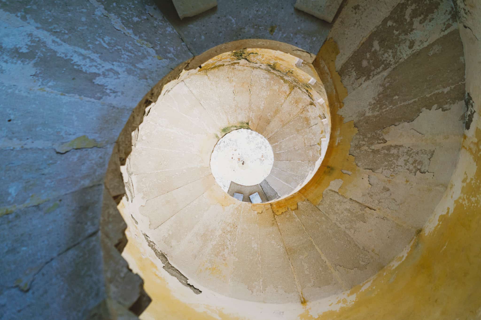 Old limestone spiral staircase shot in split-tone blue and orange while in Fort mamilla off the coast of kotor Montenegro