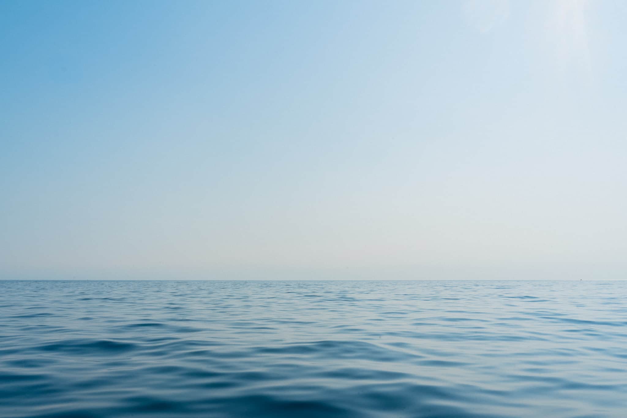 Monochromatic shot of the deep blue water in the Adriatic sea with a soft blue sky shot off the coast of Kotor Montenegro