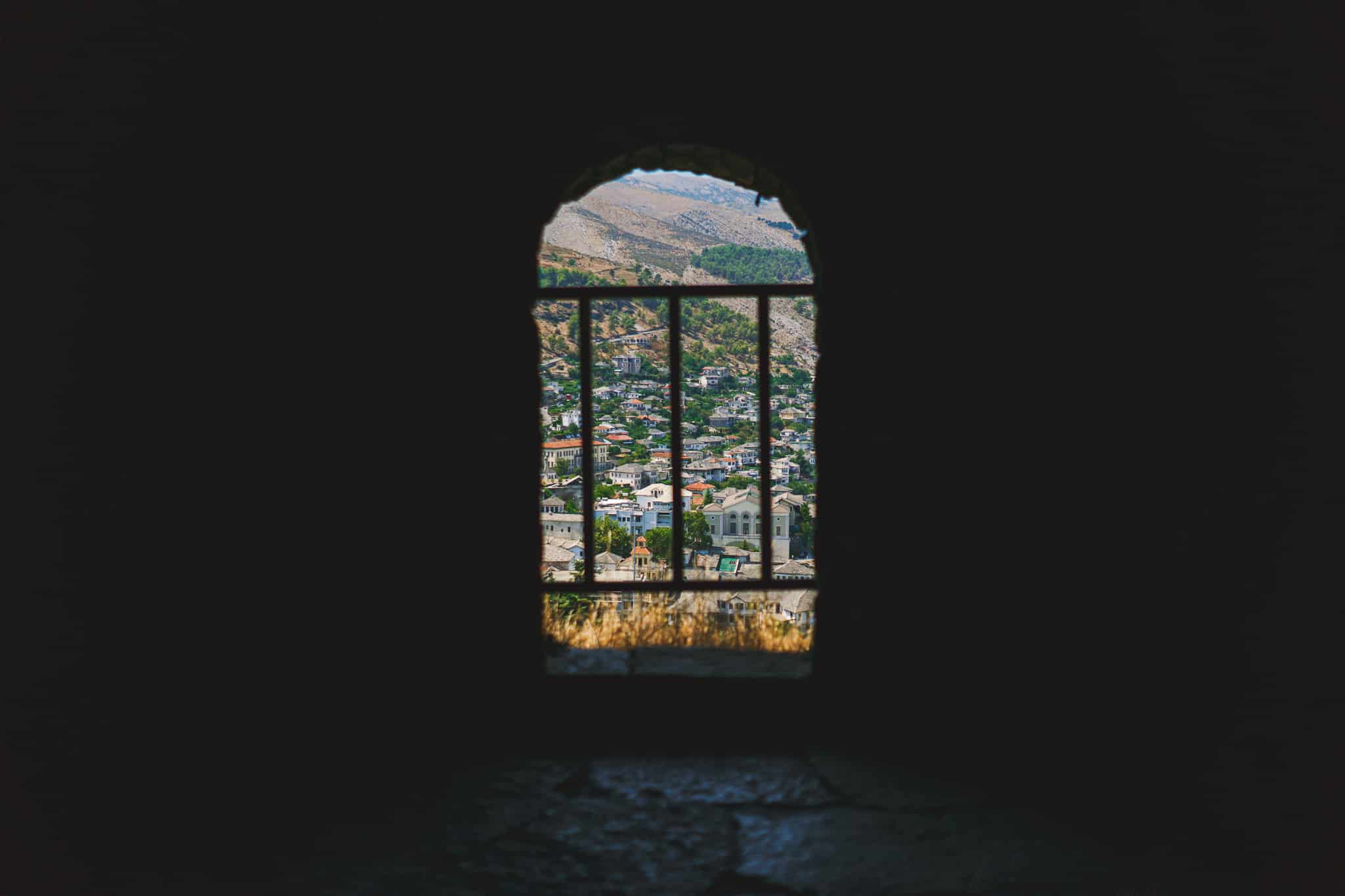 Silhouette picture within fortress in gjirokaster Albania with city lit outside