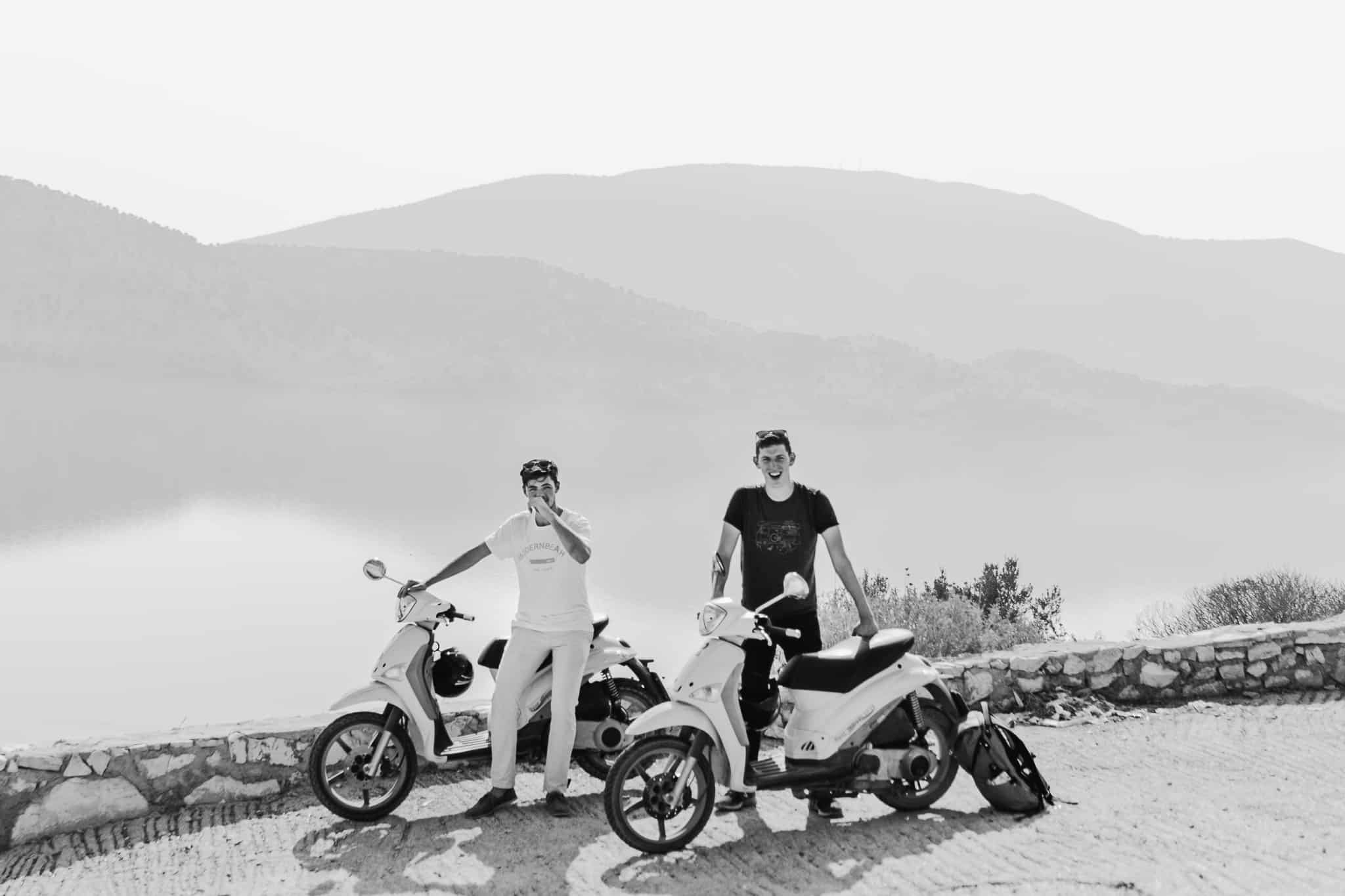 Black and white photo of Tristen Wallace with a scooter in Serande Albania