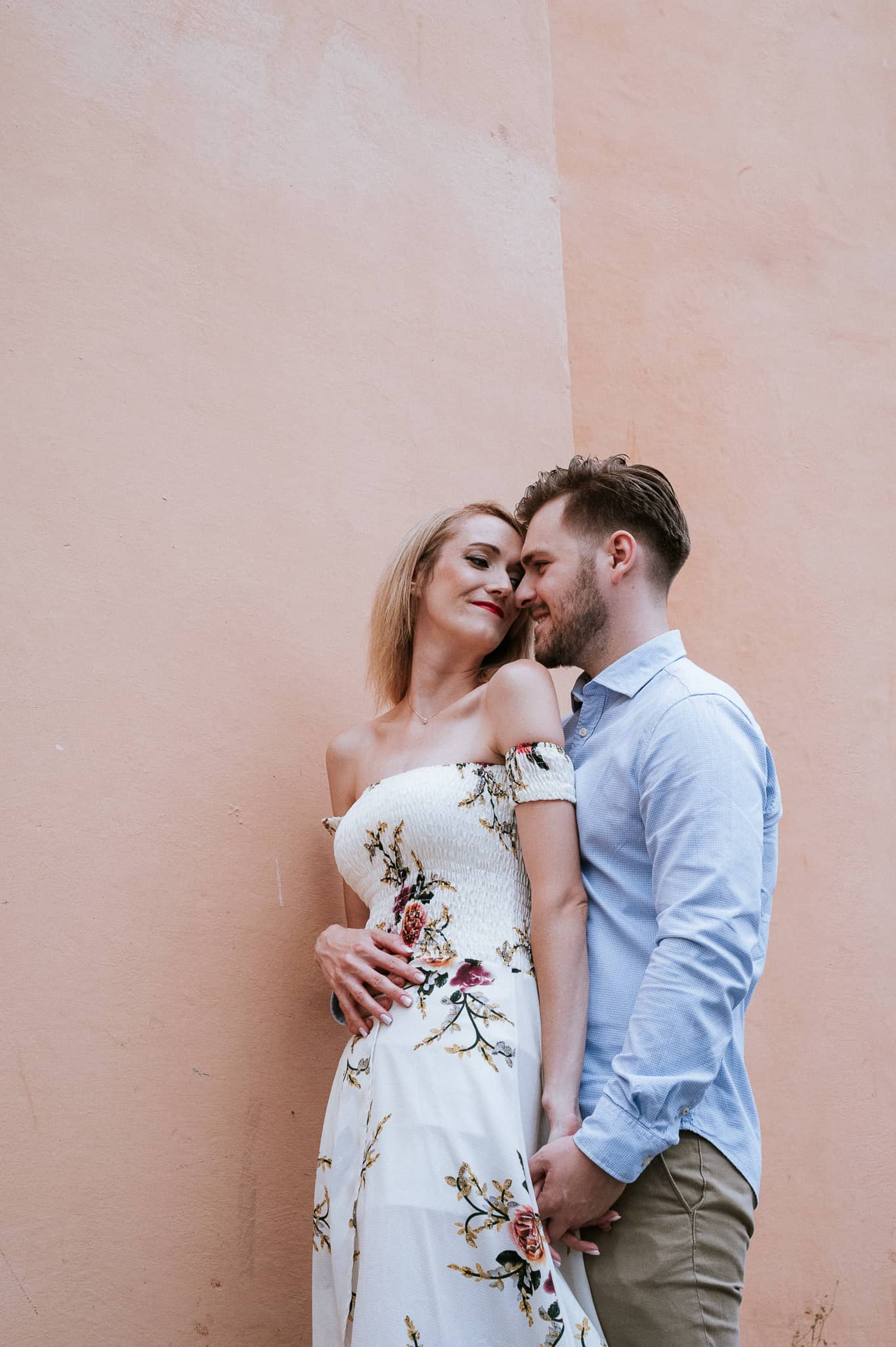 couple nuzzling during engagement photoshoot on the streets of Rome Italy 